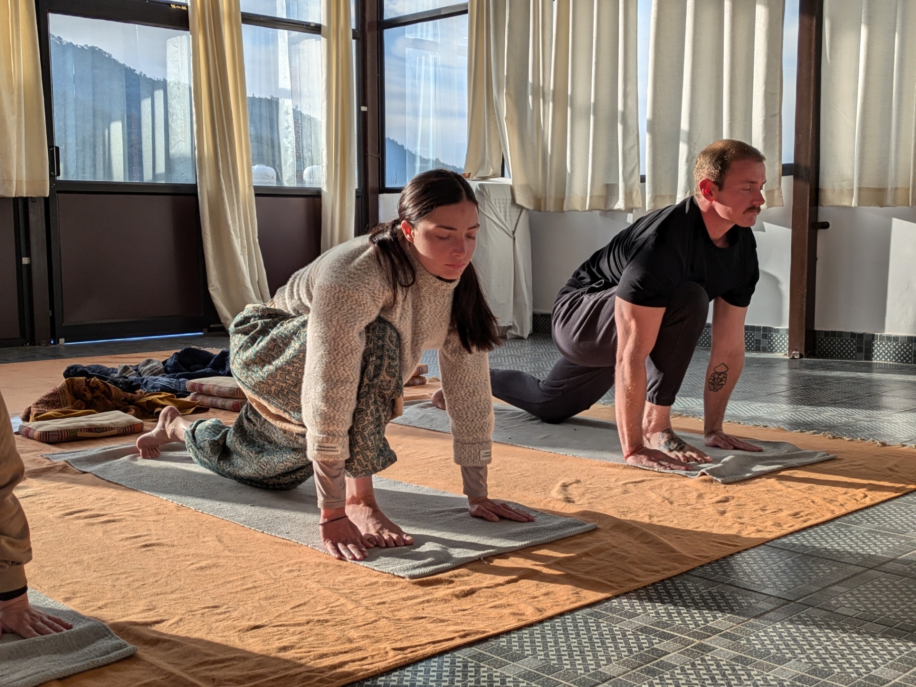 Two students in a classical hatha posture